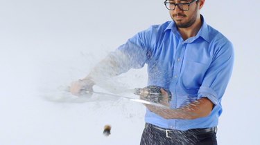 Cutting top off champagne bottle with sword.