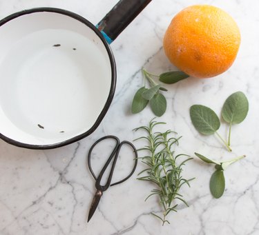 Freshly cut rosemary, sage and an orange