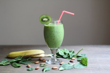 Green smoothie with kiwi garnish