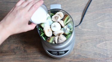 Pouring almond milk into food processor