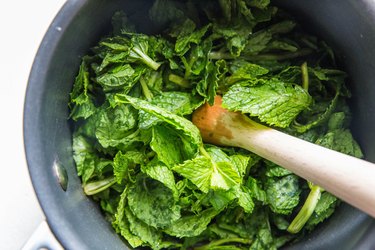 muddling mint in a saucepan