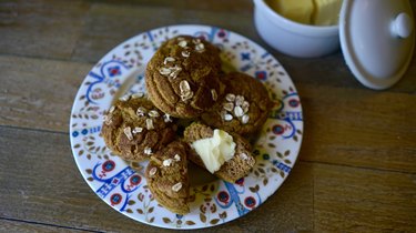 Fresh-baked pumpkin maple oat blender muffins topped with oats and cinnamon