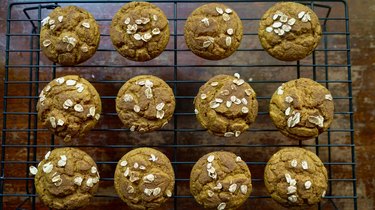 Fresh-baked pumpkin oat blender muffins topped with oats and cinnamon