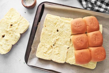 Slice dinner rolls in half