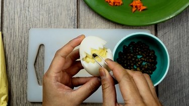 Assembling deviled egg Easter chicks.