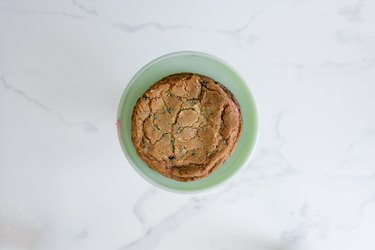 Place the first cookie on a cake stand or serving plate.