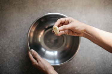 Coat the bottom of the bowl with a generous amount of garlic.