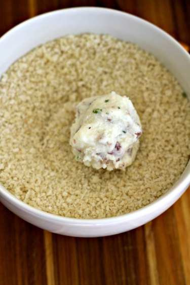 rolling mashed potato cheesy bites in breadcrumbs