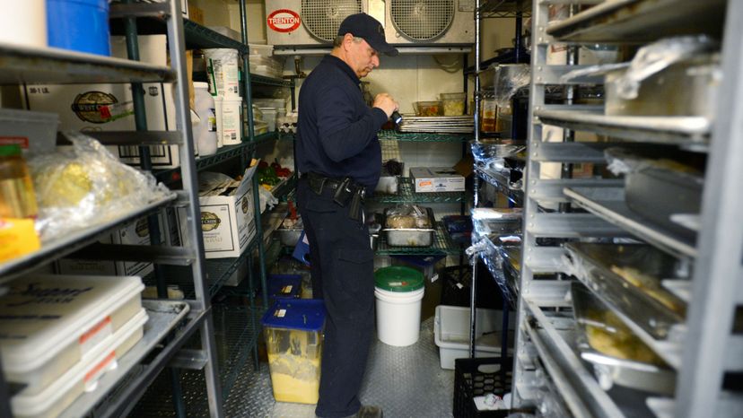 Scott Davis, a health inspector with the state of Maine, looks over a restaurant on March 14, 2013. Shawn Patrick Ouellette/Portland Press Herald via Getty Images