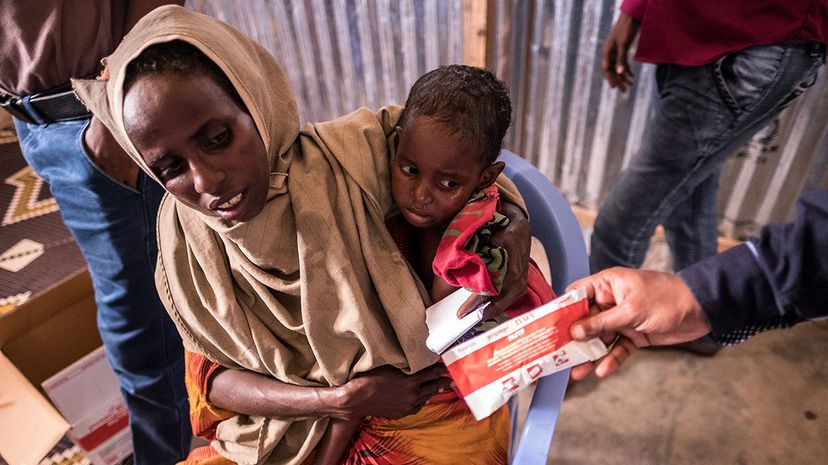 A mother and child receive peanut paste at the Turkish Red Crescent's Baydhabo camp near Mogadishu in Somalia in March 2017. Somalia is in the grip of an unprecedented and devastating food crisis threatening 6.2 million people, more than half its population. Maciej Moskwa/NurPhoto via Getty Images