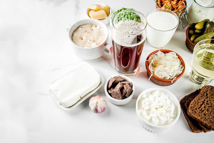 Super Healthy Probiotic Fermented Food Sources, drinks, ingredients, on white marble background copy space top view